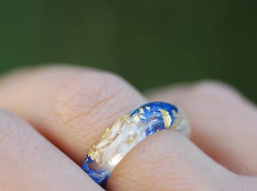 blue lapis white flowers and gold flakes ring on finger