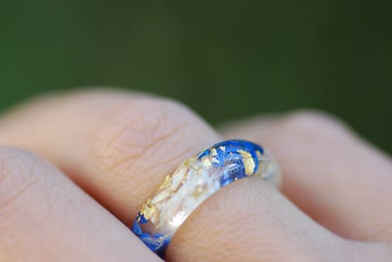 blue lapis white flowers and gold flakes ring on finger