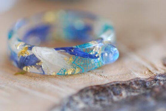 rainbow moonstone resin ring with blue and white cornflower petals