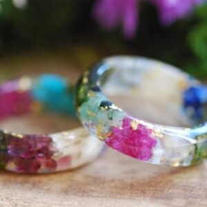 Family birthstone rings made with gemstones and metallic flakes set in resin