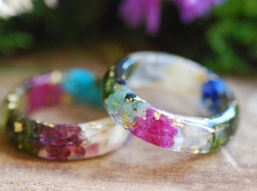 Family birthstone rings made with gemstones and metallic flakes set in resin