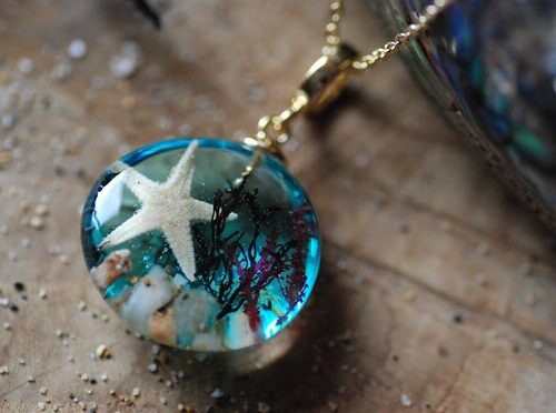 top view of beach panorama necklace with starfish and seashells