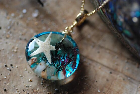 top view of beach panorama necklace with starfish and seashells