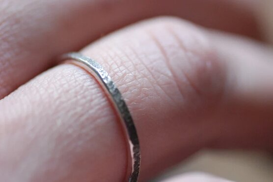 primitive silver ring on finger