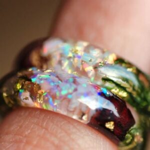 iridescent sparkling white opal ring on finger