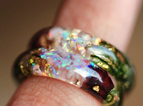 iridescent sparkling white opal ring on finger