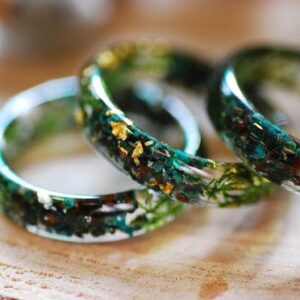 Earthy ring made of chrysocolla and jade gemstones with green moss and metallic flakes