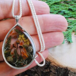 hand holding fairy forest mushroom sterling silver necklace