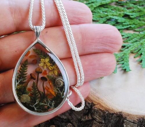 hand holding fairy forest mushroom sterling silver necklace