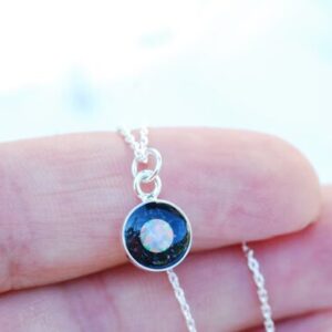 hand holding silver galaxy necklace