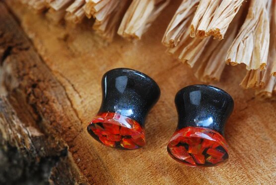 side view of red fire opal ear plugs