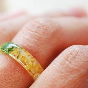 citrine moss and gold ring on finger