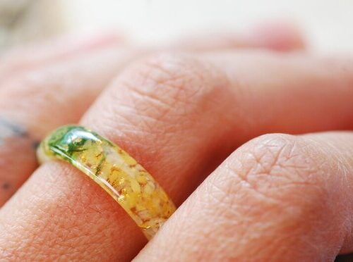 citrine moss and gold ring on finger