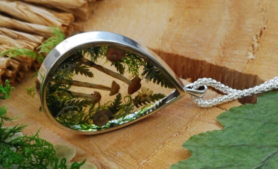 solid sterling silver pendant with forest landscape lying on side