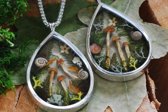 two magic forest necklaces in silver side by side