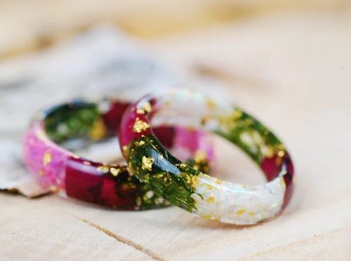 white opal and pink opal rings with rose petals and moss