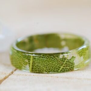 Clear resin ring band made of real green oak leaves and yellow skeleton leaf