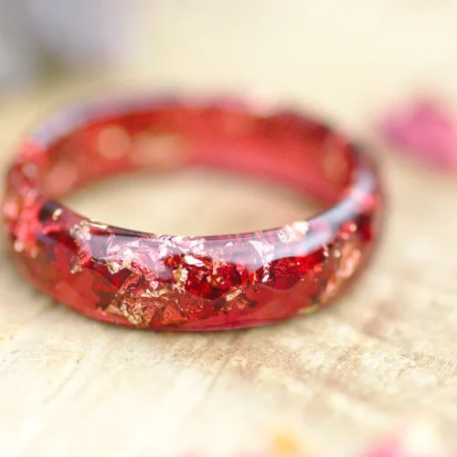 transparent red ring with gold