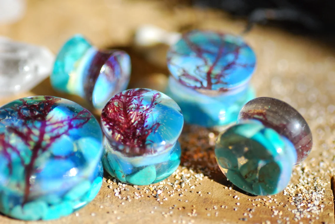 fantastic turquoise ocean with algae and opalite ear gauges