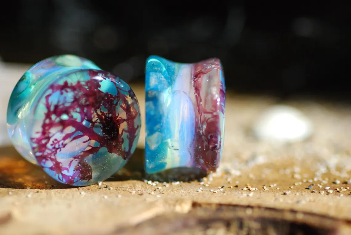 mesmerizing turquoise sea floor with sea weed ear plugs