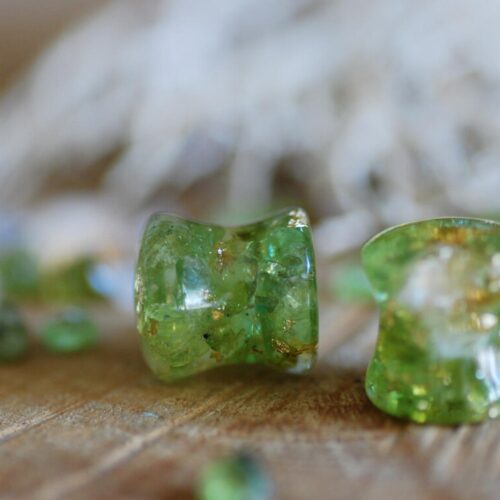 Double flared Clear resin ear gauges with peridot and citrine gemstones inside mixed with 24k gold flakes