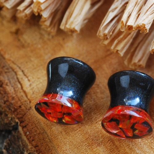 side view of red fire opal ear plugs