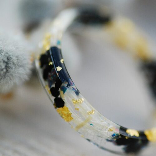 close up of black fire opal ring with flower