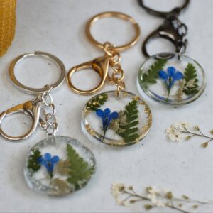 Pressed Flower Keychain with blue lobelia flowers and green ferns