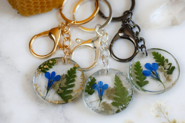Pressed Flower Keychain with blue lobelia flowers and green ferns