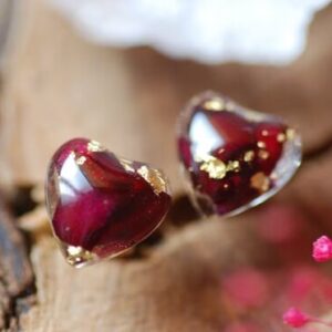Hear shape post earrings made of resin and filled with red roses and gold flakes