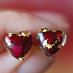 Hear shape post earrings made of resin and filled with red roses and gold flakes
