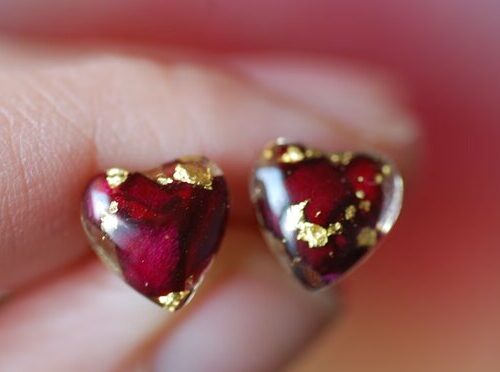 Hear shape post earrings made of resin and filled with red roses and gold flakes