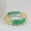 while flowers and green emerald ring