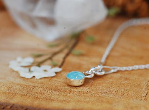 side view of tiny sterling silver bracelet with aquamarine gemstone