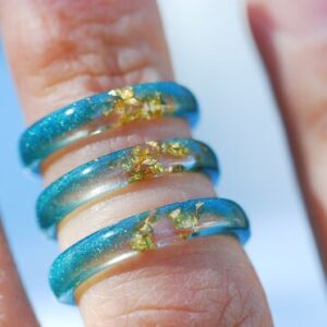 Thin Blue resin rings on finger