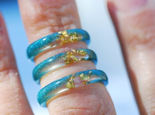 Thin Blue resin rings on finger