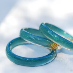 tiny resin rings in bluish teal color