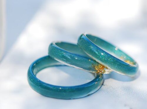 tiny resin rings in bluish teal color