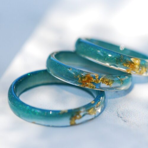 tiny resin rings in bluish teal color