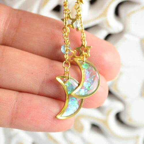 hand holding celestial earrings