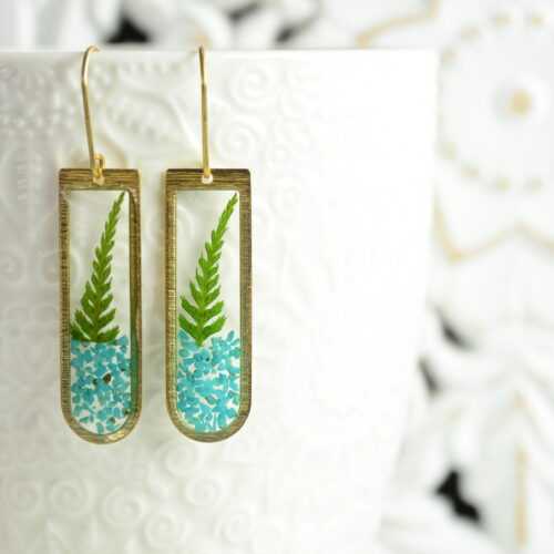 turquoise dangle fern earrings suspended on cup