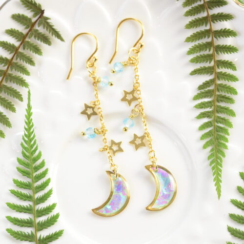 angelic crescent moon earrings between ferns