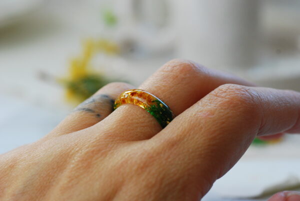 warm and bright ring with baltic amber and moss