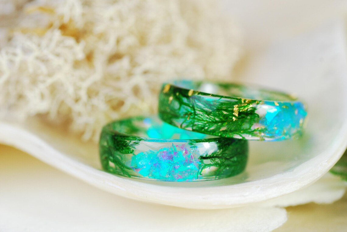 iridescent moss ring on finger