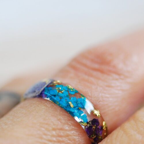 purple turquoise pressed flowers ring on finger