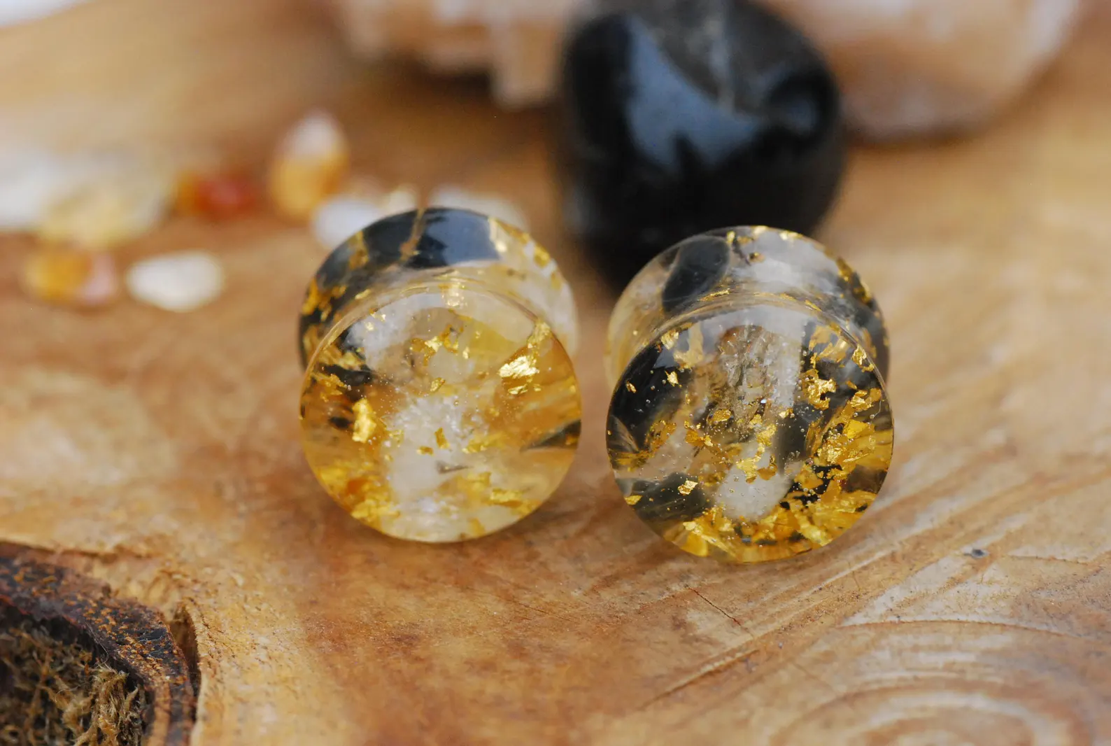 ear plugs with yellow and black stones