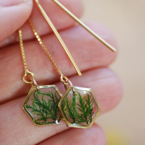 hand holding gold threader earrings with real moss