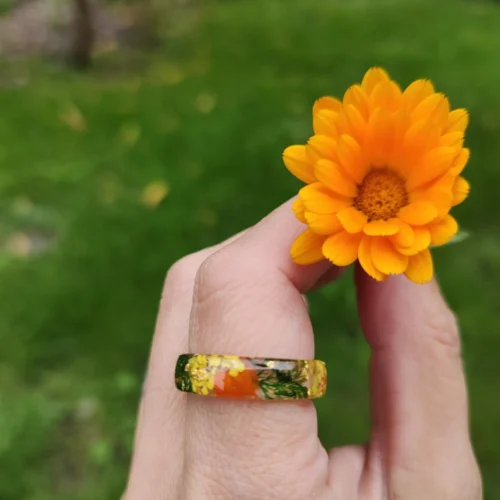 hand holding marigold flower