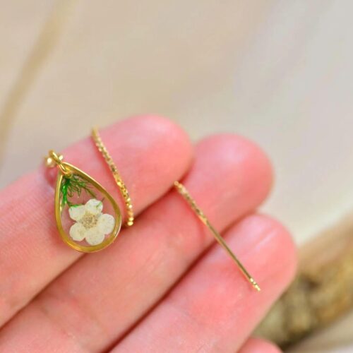 Hand holding hawthorn earrings – Alpaca Blue natural jewelry