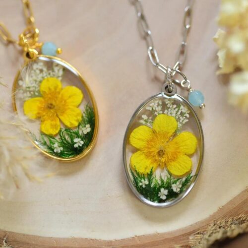 Yellow flower resin necklace handmade by Alpaca Blue with aquamarine charm